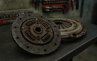 worn Valeo clutch disc and pressure plate from a Citroën Jumper 2.2 HDi laid on a workbench