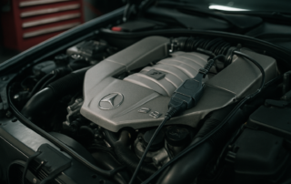 Mercedes-Benz M113 5.5L V8 AMG engine bay with ECU diagnostic connector plugged in